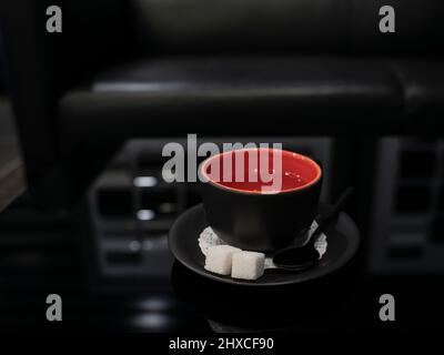 Tea pair and teapot on a black glass table. Close-up. Stock Photo