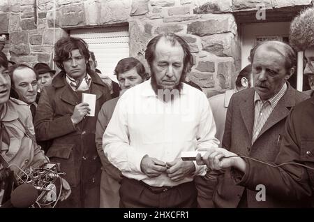 Aleksandr Solzhenitsyn (1918-2008), Russian author and outspoken critic of communism, in Cologne, Germany, meeting with reporters on February 14, 1974 after his expulsion from Russia. Solzhenitsyn is best known for The Gulag Archipelago (1973), the publication of which outraged the Soviet authorities. Solzhenitsyn spent eight years in a Soviet Gulag forced-labor camp for writing derogatory comments in private letters to a friend, Nikolai Vitkevic, about Joseph Stalin's conduct of World War II. Stock Photo