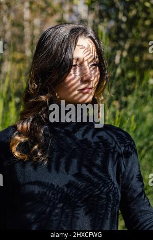Young woman enjoying the sunny day looking to the side Stock Photo