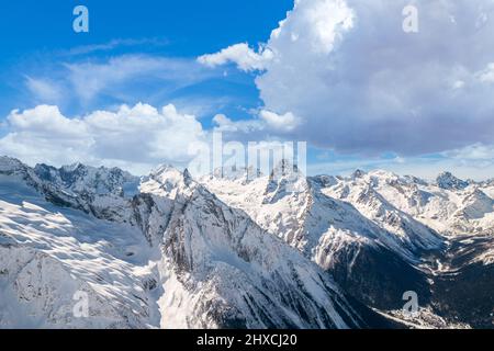 Fluffy cloud over mountains in winter  Stock Photo