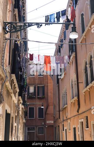 Narrow alley with taut clothesline from house to house in Venice, Italy Stock Photo