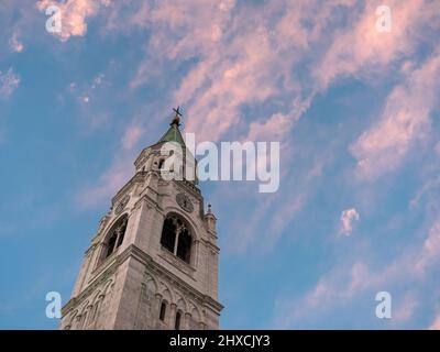 Campanile Bell Tower or Spire and Evening Sky in Cortina d'Ampezzo, Italy Stock Photo