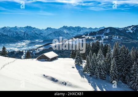 Snowy mountain landscape above Gunzesried valley on a sunny day in winter. View to the Illertal valley near Oberstdorf. Allgäu Alps, Bavaria, Germany, Europe Stock Photo