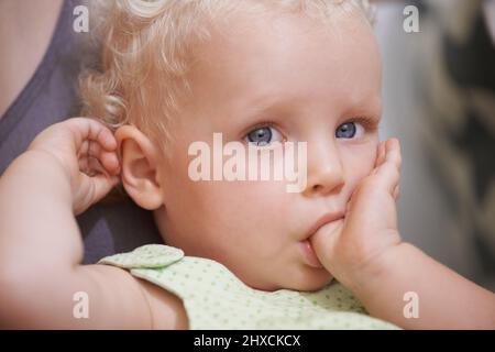 She is just so adorable. A cute young toddler with curly blonde hair. Stock Photo