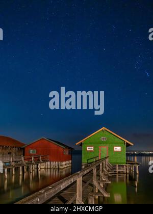 Colorful boathouses at night, Schondorf, Ammersee, Fünfseenland, Upper Bavaria, Bavaria, Germany, Europe Stock Photo