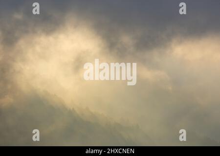 Europe, Germany, Lower Saxony, Veckerhagen. The misty Weserbergland in the morning light. Stock Photo