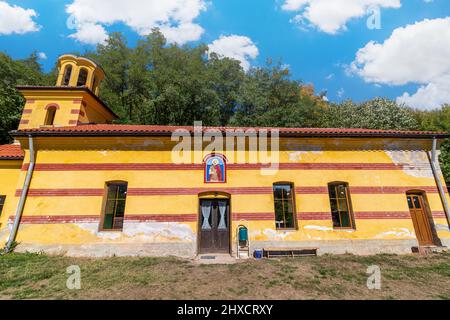 Small church in a village with beautiful blue sky and clouds in the background Stock Photo