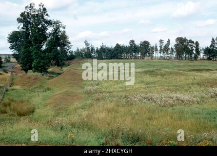 Remains of Ardoch Roman fort earthworks outside the village of Braco in Perthshire, Scotland, about 7 miles south of Crieff. Archival scan from a slide. September 1972. Stock Photo