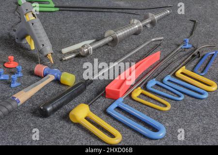 Paintless Dent Repair Kit Tools Set On The Work Table. Tools For Repair Dents On Car Body. Stock Photo