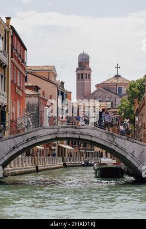 Small canal with Venetian bridge overlooking Chiesa di San Nicola da Tolentino in Santa Croce neighborhood in Venice, Italy. Stock Photo