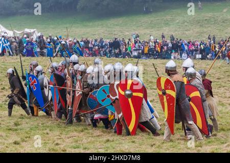England, East Sussex, Battle, The Annual Battle of Hastings 1066 Re-enactment Festival, Participants Dressed in Medieval Norman Armour Advancing into Battle Stock Photo