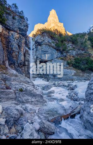 Europe, Italy, Veneto, province of Belluno, Taibon Agordino, small waterfall in Corpassa valley dominated by the Trieste tower, civetta group, Dolomites Stock Photo