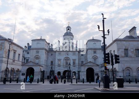 Tourists outside Horse Guards Parade in the evening as seen from Whitehall. Surveillance cameras in the foreground, London. Stock Photo