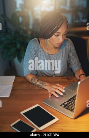 Shes got deadlines to meet. Cropped shot of a young woman working late in the office. Stock Photo