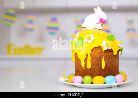 Easter cake with a rabbit and painted eggs on the table. Religious holiday. Stock Photo