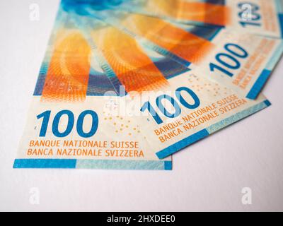 Fanned 100 Swiss Franc banknotes on a white background. Stock Photo