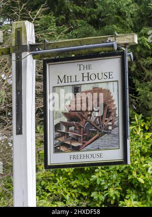 Traditional hanging pub sign at The Mill House - freehouse public house - North Warnborough, Hook, Hampshire, England, UK Stock Photo