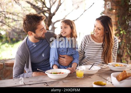 Delightful breakfast time. Cropped shot of a family having a meal together outside. Stock Photo