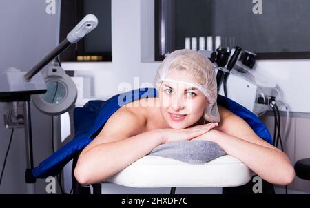 Female during body procedure in cosmetology office Stock Photo