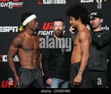 Las Vegas, USA. 11th Mar 2022. March 11, 2022, LAS VEGAS, LAS VEGAS, NV, United States: LAS VEGAS, NV - March 11: Sodiq Yusuff (L) vs Alex Caceres (R) face-off for the official weigh-in at the UFC Apex for UFC Vegas 50 - Santos vs Ankalaev - face-off on March 11, 2022 in LAS VEGAS, United States. (Credit Image: © Louis Grasse/PX Imagens via ZUMA Press Wire) Credit: ZUMA Press, Inc./Alamy Live News Stock Photo