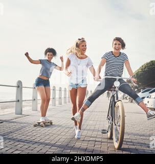 Friends put the f in fun. Shot of three friends having fun on the promenade. Stock Photo