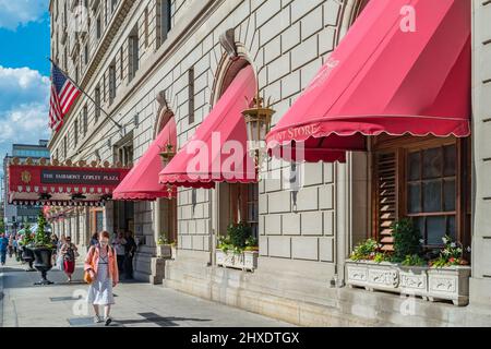 Pedestrians walk in front of the Fairmont Copley Plaza Hotel in downtown Boston, Massachusetts, USA on a sunny day. Stock Photo