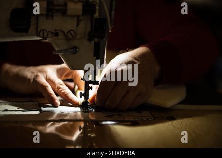 Sewing machine and men's hands of a tailor Stock Photo