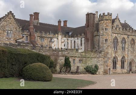 view of the front of a retro gothic castle with tall chimneys and turrets against a blue sky Stock Photo