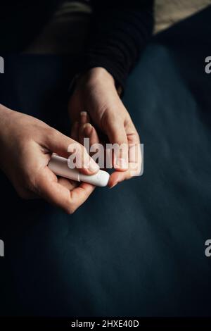 woman uses finger lancet to check blood sugar level. diabetic care and health concept Stock Photo