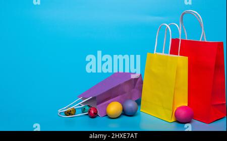 easter eggs and several paper bags on a blue background Stock Photo