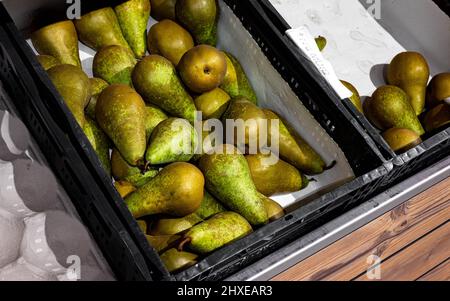 Pears in a fruit basket being displayed in a supermarket Stock Photo