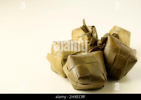 Ketupat, special dish served at Eid Mubarak or  Ied Fitr celebration in Indonesia. Ketupat is is a type of dumpling made from rice packed inside a dia Stock Photo