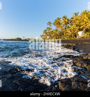Sunrise on Waves Crashing  Against The Pahoehoe Lava Shoreline of Punalu'u Beach, Hawaii Island, Hawaii, USA Stock Photo