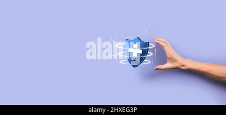 Businessman hold Shield with plus Low polygonal icon, medicine icon.Health shield.Medical logo template,protection symbol with cross sign,healthcare s Stock Photo