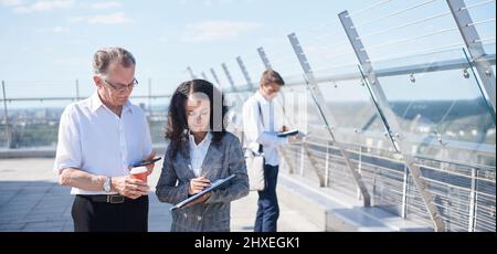business colleagues discussing a financial document during a coffee break . Stock Photo