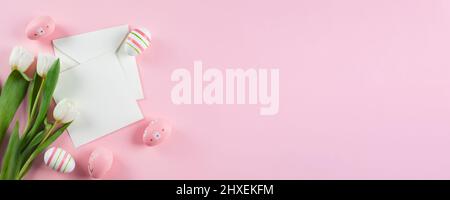 Easter Banner. Easter eggs, empty card blank and spring tulips. Mockup concept. Long banner for design, web page Stock Photo