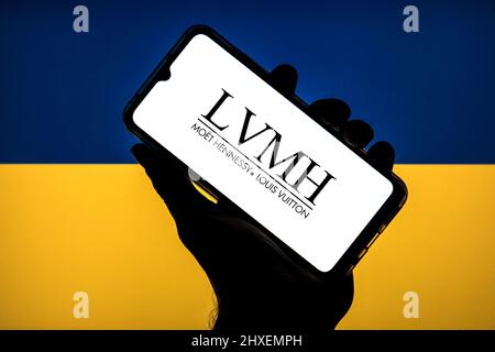 LVMH logo of stock price on the screen of smartphone in mans hand