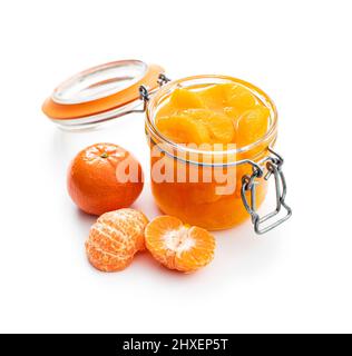 Canned tangerine. Pickled mandarin fruit in jar isolated on a white background. Stock Photo