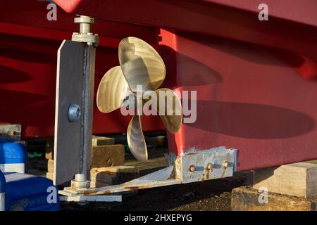 The rudder and propeller of a boat in dry dock Stock Photo