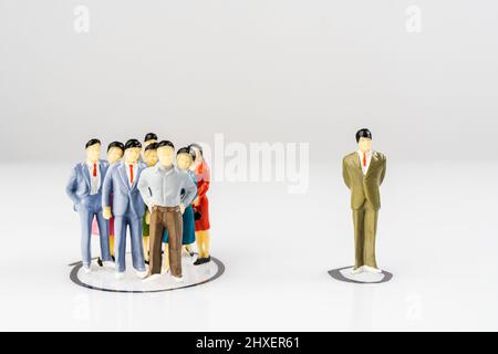 A group and a single miniature models isolated within a circle drawn on a surface Stock Photo