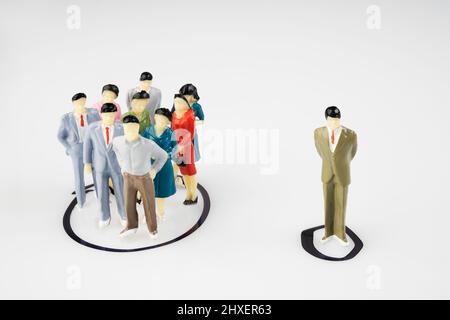 A group and a single miniature models isolated within a circle drawn on a surface Stock Photo