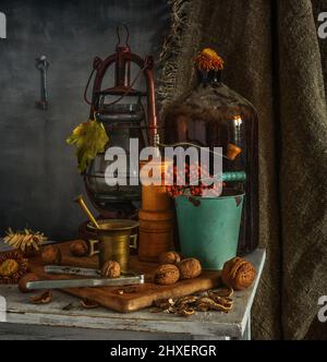 https://l450v.alamy.com/450v/2hxergr/still-life-with-a-kerosene-lamp-a-large-dark-glass-bottle-a-bronze-mortar-a-hand-mill-and-nuts-village-still-life-vintage-2hxergr.jpg