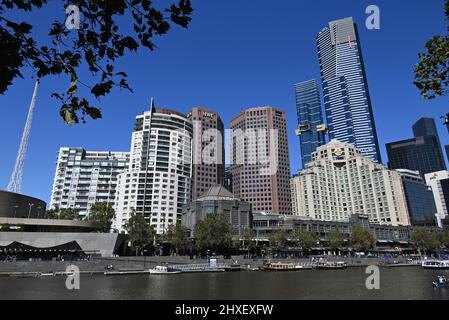 Southbank's skyline, featuring Quay West, HWT, Landham, Eureka Tower, and PWC buildings, taken from ground level on the Yarra River's northern bank Stock Photo