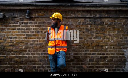 Portrait of an Asian construction worker wearing hard hat and high visibility vest. Stock Photo