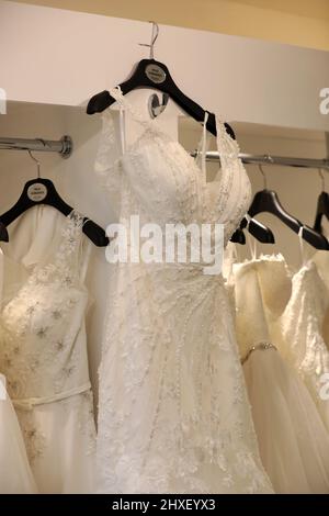 A selection of white wedding dresses pictured in a dress shop in Chichester, West Sussex, UK. Stock Photo