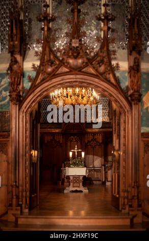 Splendid chandelier with lit candles in a beautiful room of an old mansion Stock Photo