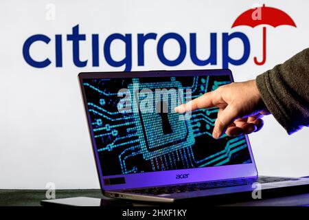 Laptop with lock symbol on screen on background of  Citigroup logo. Finger points to lock symbol. Concept of data hacking. Stock Photo