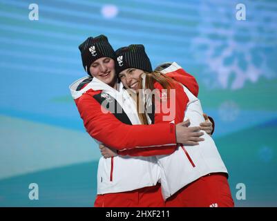 Barbara Aigner of Austria and guide Klara Sykora celebrate after