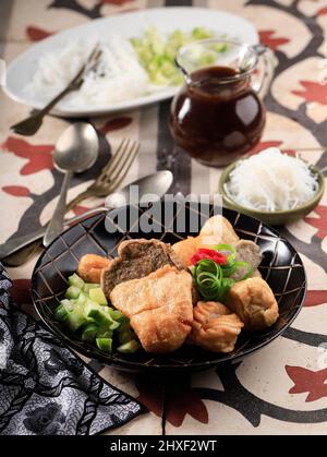 Pempek is Fish and Tapioca Served with Sweet and Sour Kuah Cuka (Cuko) or Vinegar Sauce. This Dish Popular from Palembang, Indonesia. Stock Photo