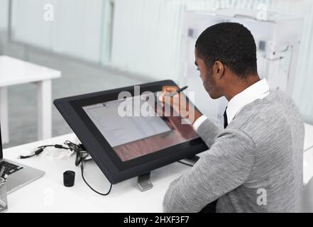 Smart technology makes everything easier. A young man working on a large touchscreen. Stock Photo